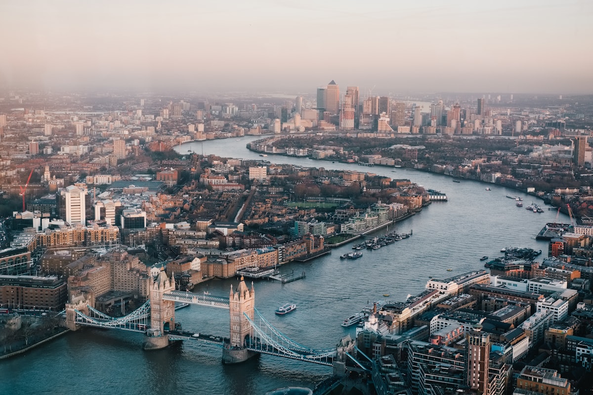 Tower Bridge and London skyline at dusk with city lights